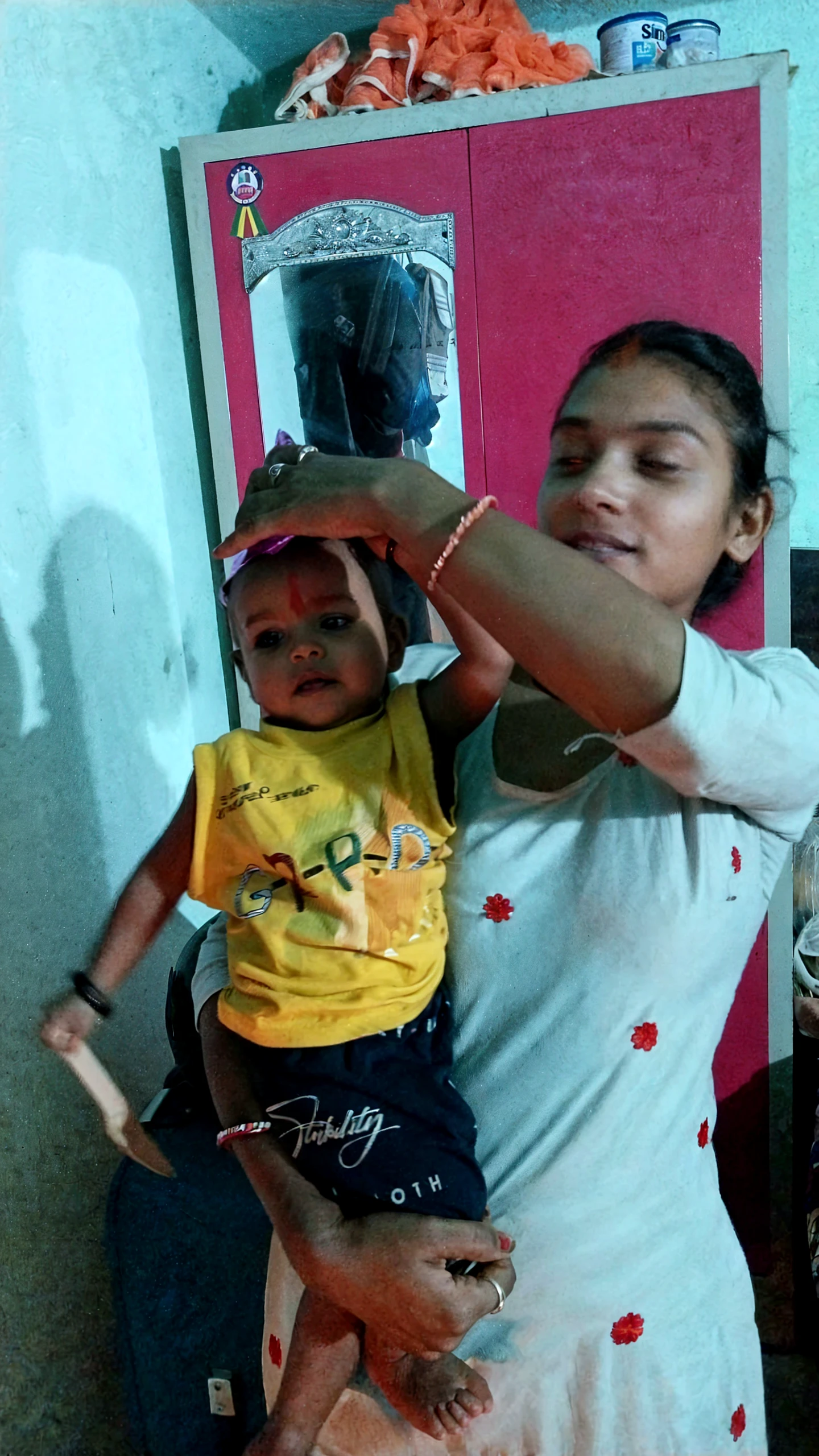 A little boy helping his mom to unstrap her bra.