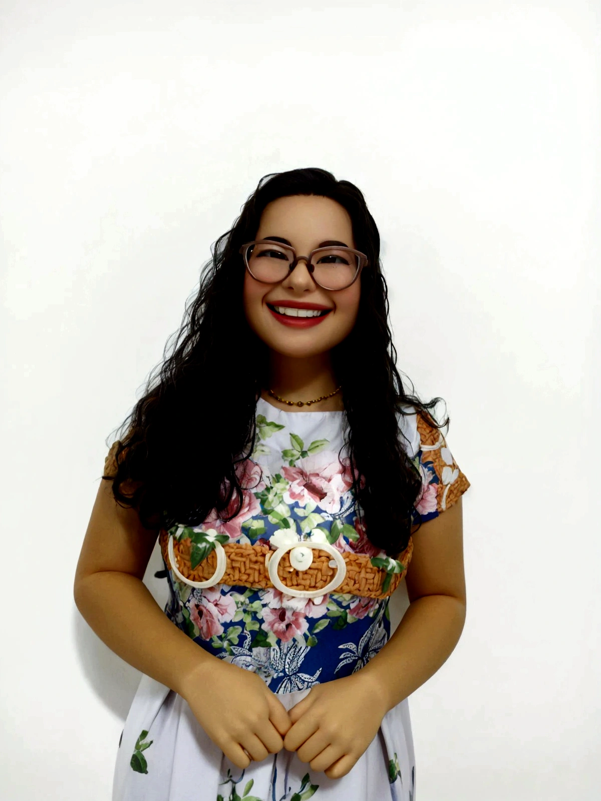 there is a smiling woman with long hair and glasses posing for a photo