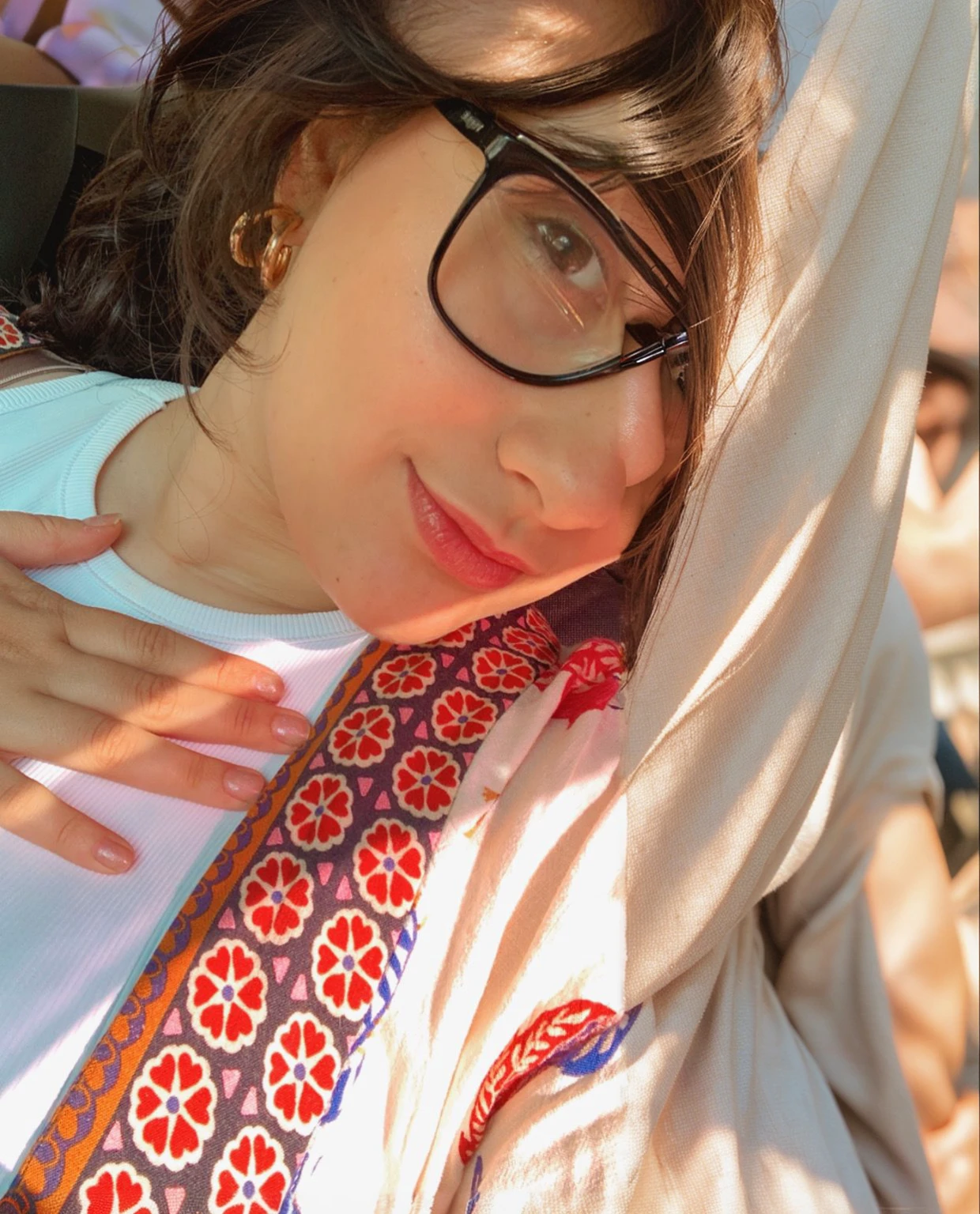 there is a woman with glasses close up half-length photo, Hand on cheek, very low quality image, hand on her chin, with the sun shining on it, perfect, crisp sunlight, profile image, fair skinned Persian girl, uncut, close-up - ver, diary in her hand, candid photo