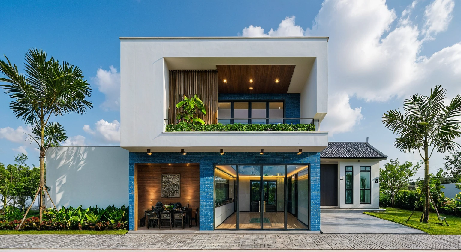 Raw photo, Masterpiece, high quality, best quality, authentic, super detail, outdoors, house style modern on the street , a traditional single-story Thai-style house, large glass window and at the first floor, blue tile roof, white wall, pavement, grass, trees, tropical plants, clear sky, cloud, (nature light), (daylight:1.2)