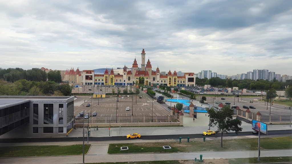 there is a large parking lot with a lot of cars parked in it, view from window on megapolis, ground level view of soviet town, russian city, photo taken from far, surrounding the city, taken with sony alpha 9, town in the background, shot from 5 0 feet distance, with a city in the background, viewed from bird's-eye