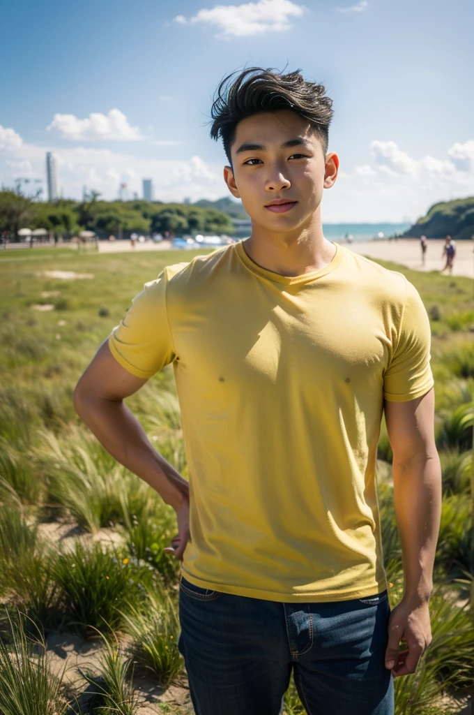 A handsome, muscular young Asian man looks at the camera. In a plain yellow t-shirt , Fieldside, grass, beach, sunlight