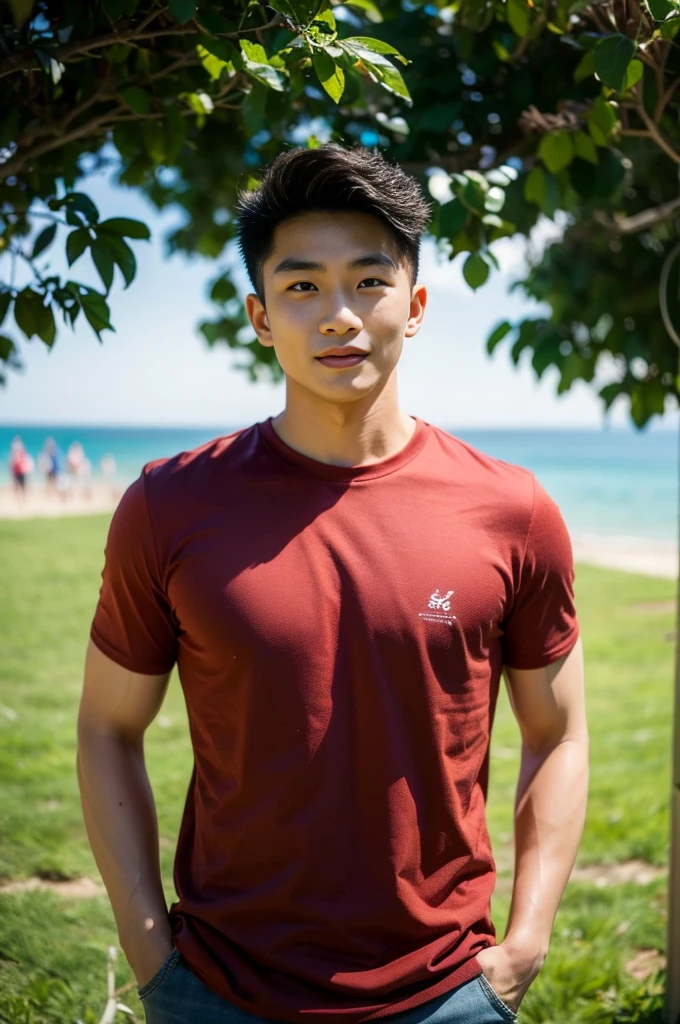A handsome, muscular young Asian man looks at the camera. In a plain red t-shirt, Fieldside, grass, beach, sunlight