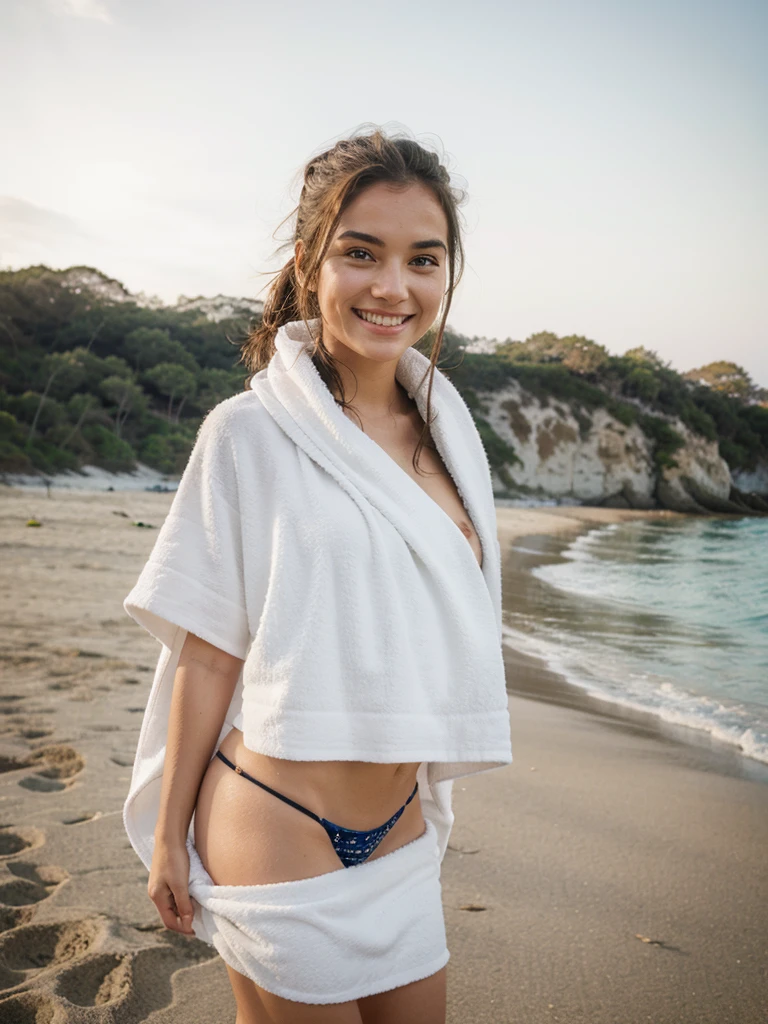 Girl, smiling, wearing towel on beach