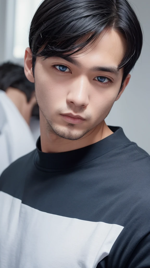 a black-haired, black-eyed, white-skinned man wearing a blue shirt