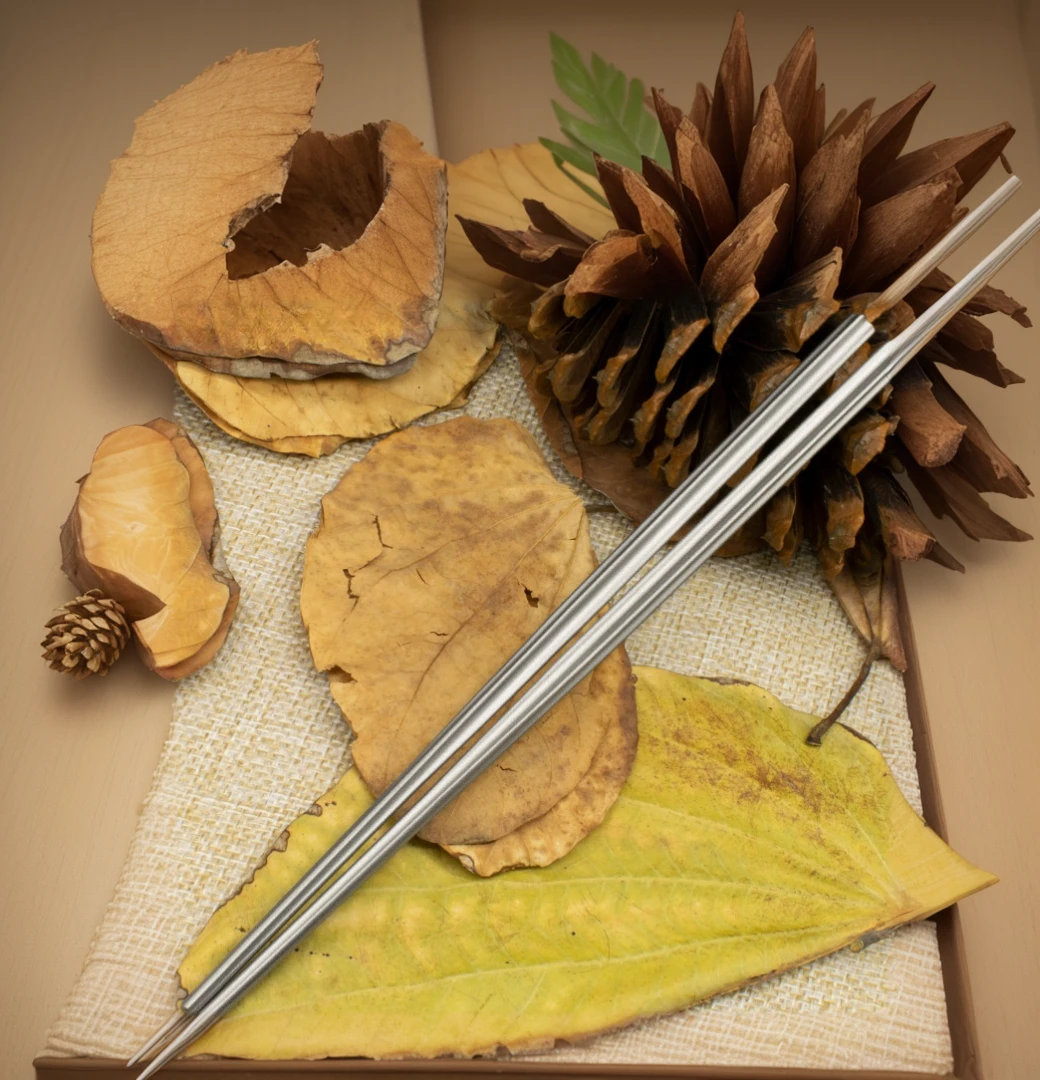 there are two Chopsticks sitting on a leaf with pine cones, Chopsticks, Product introduction photos, High quality product image”, Very detailed product photos, Micro product photos, 88 mm, 2447, straw, Year 3022, 85 mm, 8 5 mm, 85 mm, 84 mm, 8 4 mm