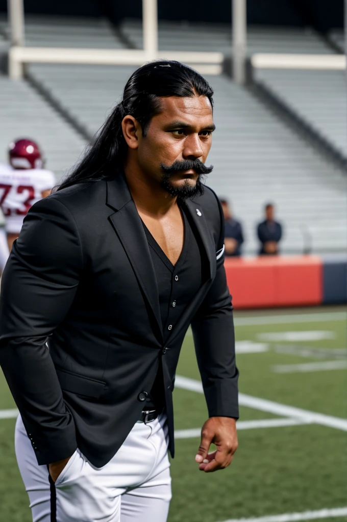 man from samoa, 30 years old, very muscular body, long black hair, football coach, handlebar moustache, at a football field, wearing black business suit