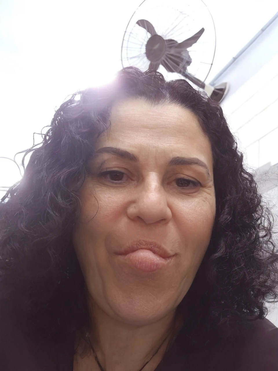 Light brunette, short, black eyes, full mouth, black curly hair, 47 years old and short height