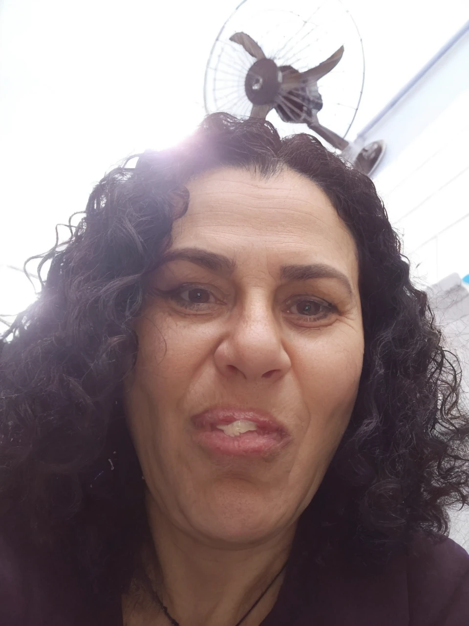 Light brunette, short, black eyes, full mouth, black curly hair, 47 years old and short height