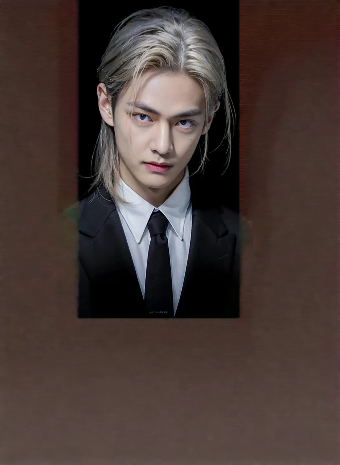 Expand the image by completing the person's body, gala suit complexion of a young asian man.