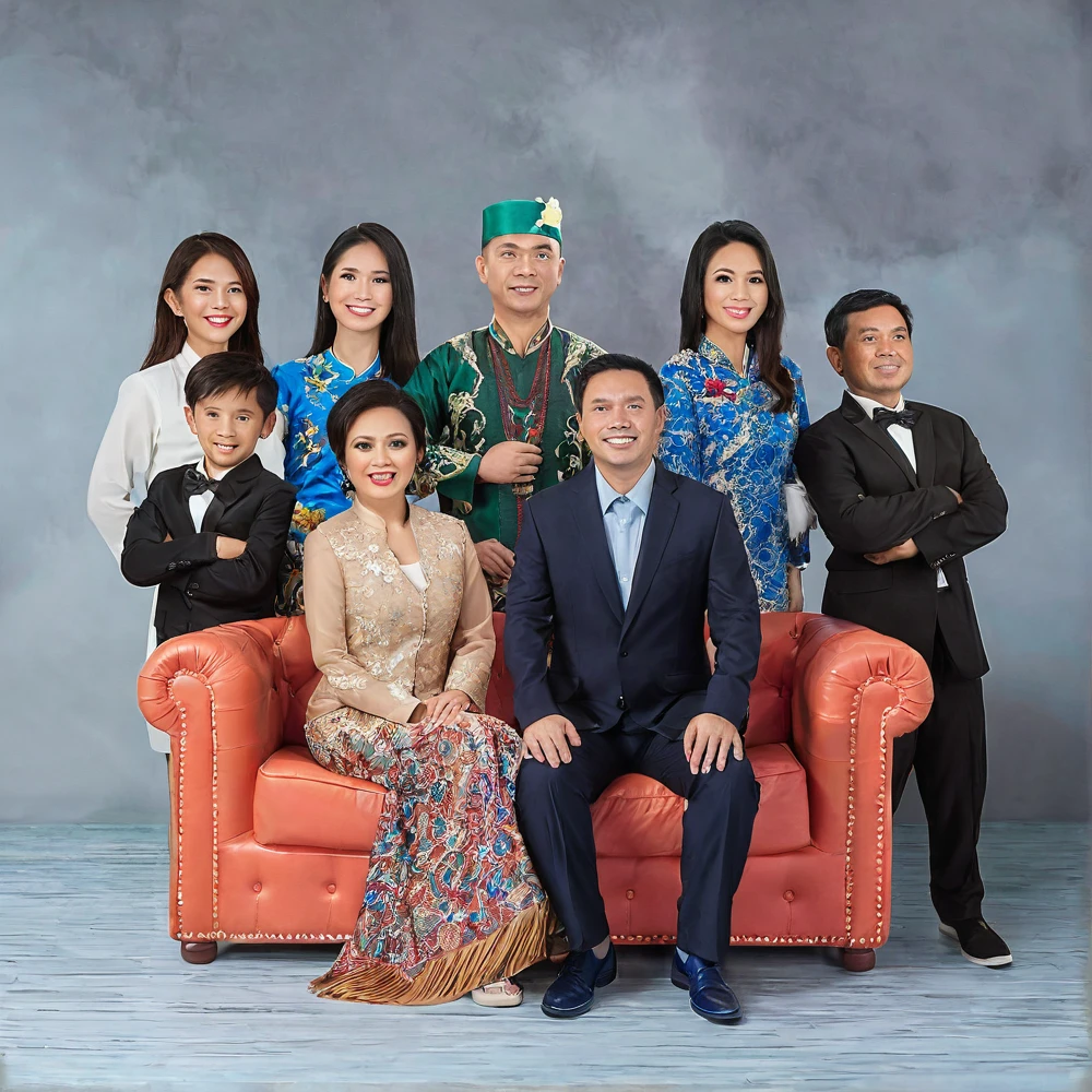 there are a group of people sitting on a couch together, an indonesian family portrait, portrait shot, family portrait, barong family, family photography, formal portrait, family, photo portrait, duy beni serial, backdrop, promotional portrait, portrait picture, corporate photo, group portraits, portrait image, portrait photo of a backdrop, ao dai