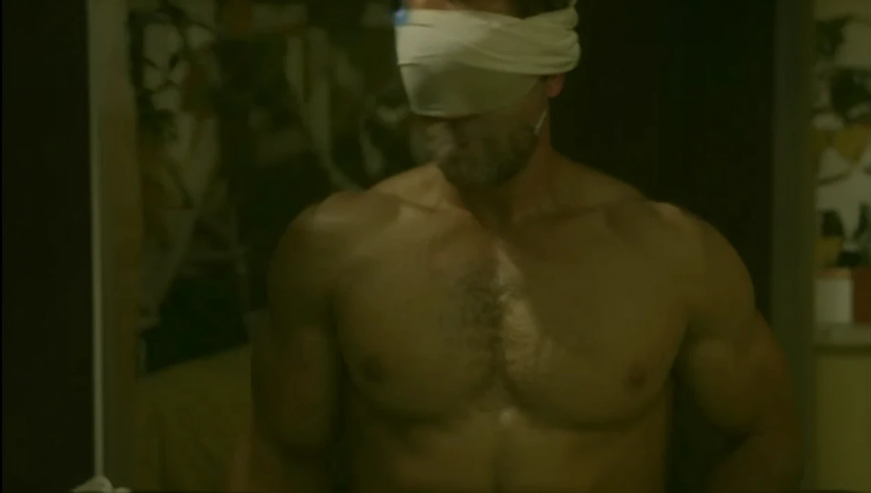 Hot, sweaty, beefy, shirtless dad on the bed with his hands tied up behind his head. He also has big, bushy, hairy armpits. Big cockhead bulge on his underwear. (He is also blindfolded with a cloth tied around his eyes, covering his eyes). (He also has a dad bod).