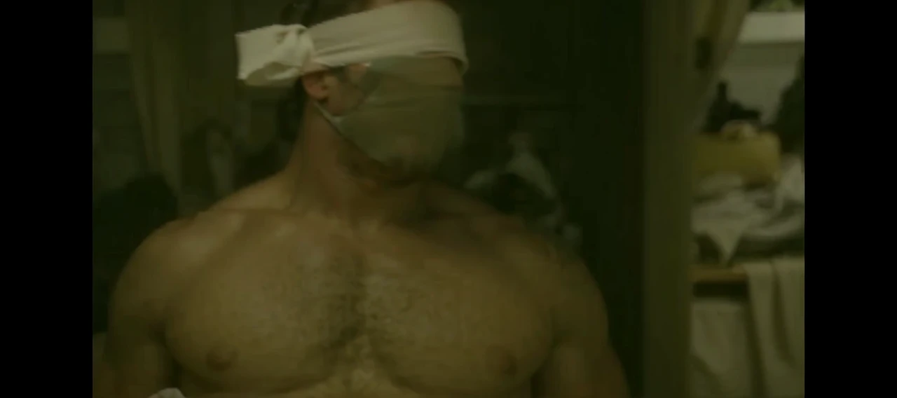 Hot, sweaty, beefy, shirtless dad on the bed with his hands tied up behind his head. He also has big, bushy, hairy armpits. Big cockhead bulge on his underwear. (He is also blindfolded with a cloth tied around his eyes, covering his eyes). (He also has a dad bod).