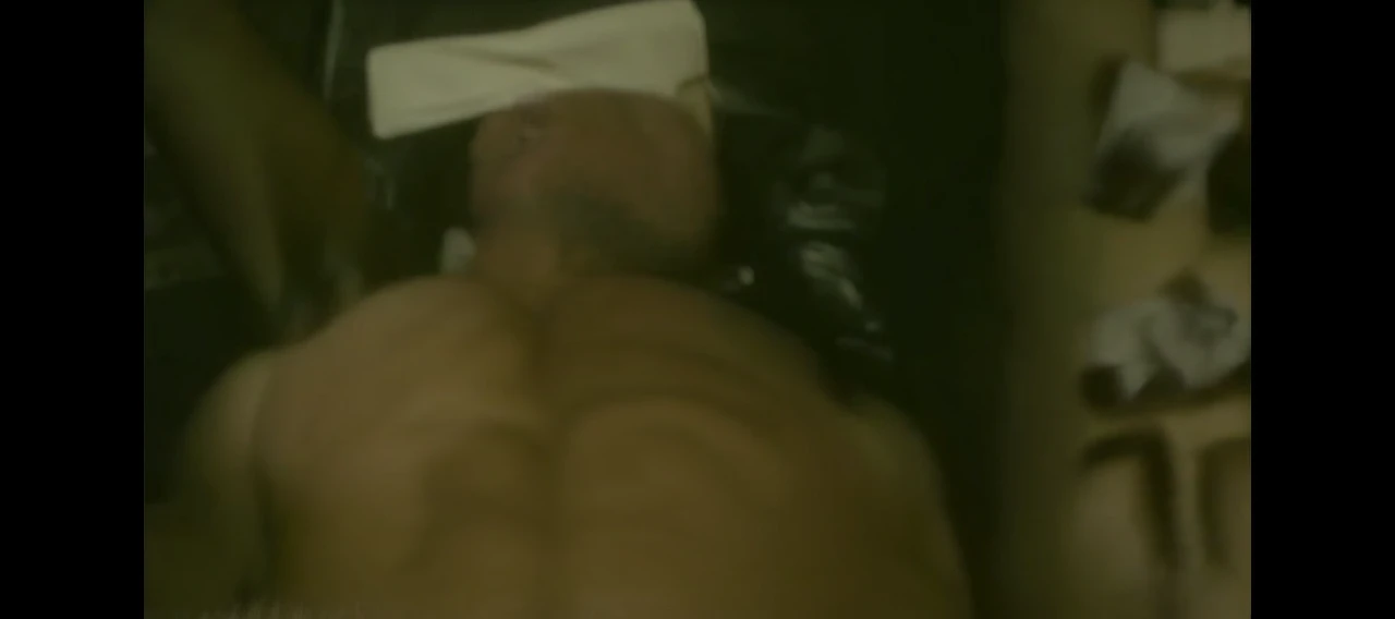 Hot, sweaty, beefy, shirtless dad on the bed with his hands tied up behind his head. He also has big, bushy, hairy armpits. Big cockhead bulge on his underwear. (He is also blindfolded with a cloth tied around his eyes, covering his eyes). (He also has a dad bod).