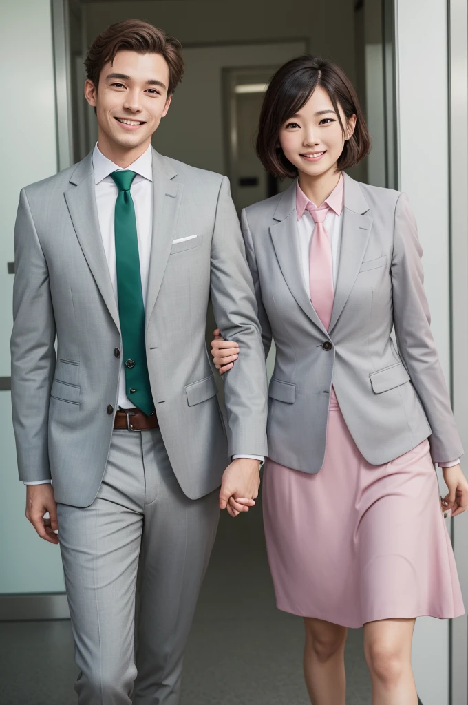 Couple in light gray suits and pink ties and green knee-length dress smiling for the photo