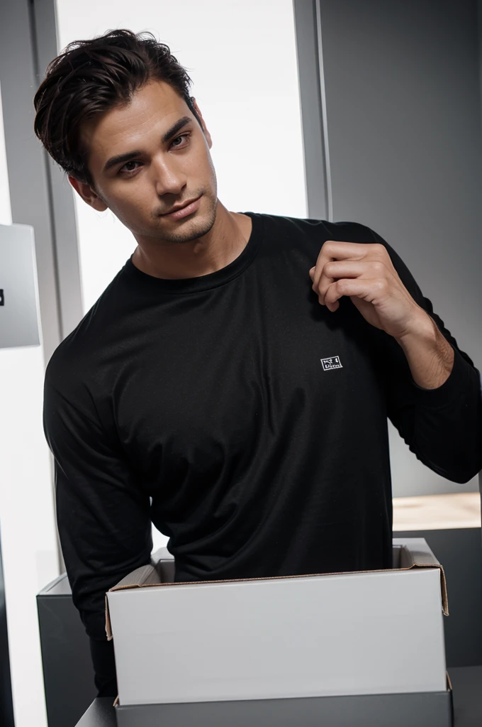 Handsome man wearing a black shirt with a logo on the left chest next to a white box