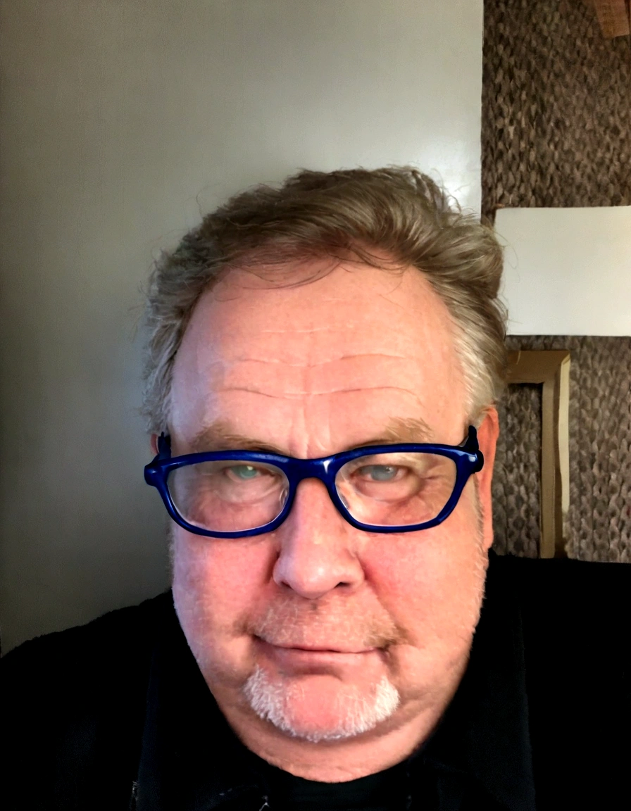 there is a man with glasses sitting at a table with a cell phone, taken in the early 2020s, p. craig russell, craig russell, headshot profile picture, stocky, profile image, photo of a 50-year-old white man, profile picture, andy richter, 45 years old men, photo from 2022