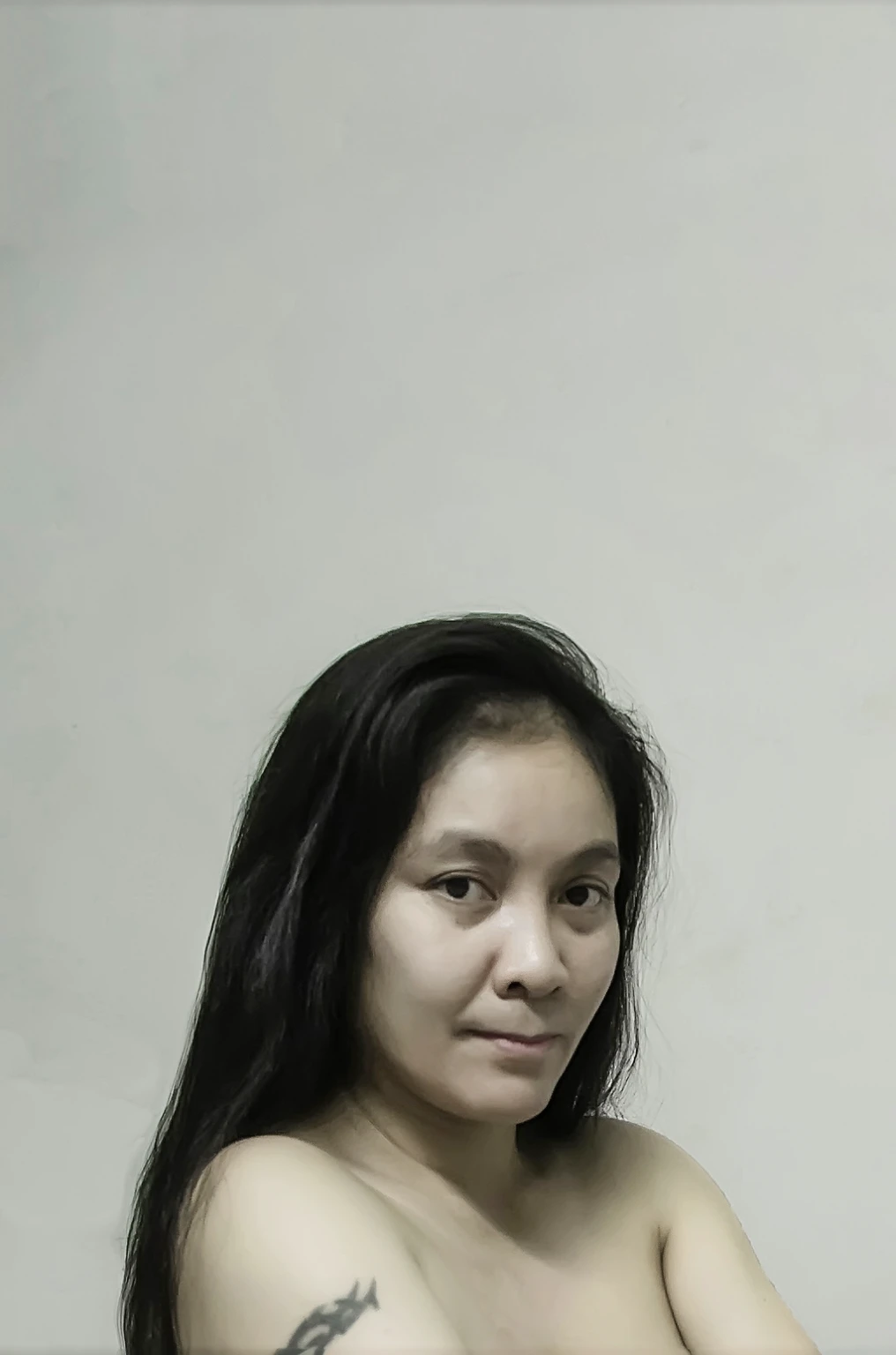 There was a naked woman sitting on a bed with a tattoo on her arm., laying in the bedroom, Posing on the bed, very sexy pose, sitting on the bed, hot sexy body, sitting on the bedของเธอ, in my bedroom, sexy girl, Full body shot, Sitting in the bedroom, Take a full body photo, sexy pose, uhd candid pictures of dirty Symmetrical figure, naked