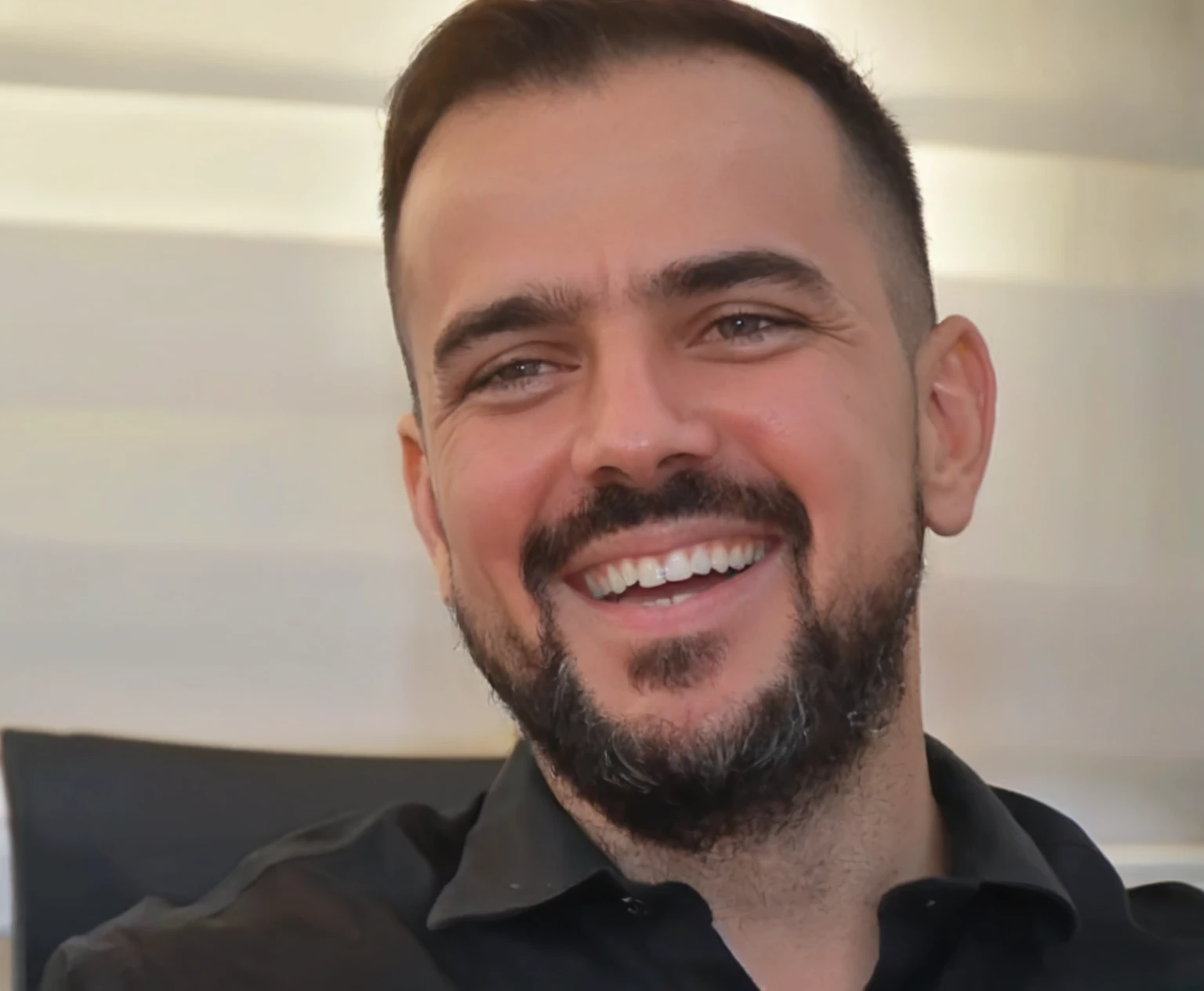 smiling man with beard and black shirt sitting on chair, henrique alvim corrêa, david rios ferreira, icaro carvalho, Ed Durmisevic, michael vicente, Marco Bucci, gui guimaraes, Luís Ricardo Falero, aykut aydogdu, toni infante, julian calle, Stefano Brunesci, edu souza
