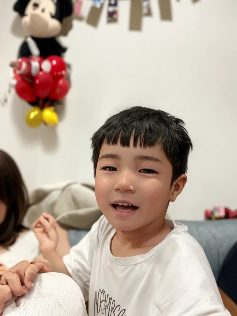 there is a young boy with a mohawk sitting on the floor, 2 years old, south east asian with round face, nivanh chanthara, young child, detailed face of a asian boy, with cute doting eyes, young cute wan asian face, boy with neutral face, thawan duchanee, ayan nag, looking intensely at the camera