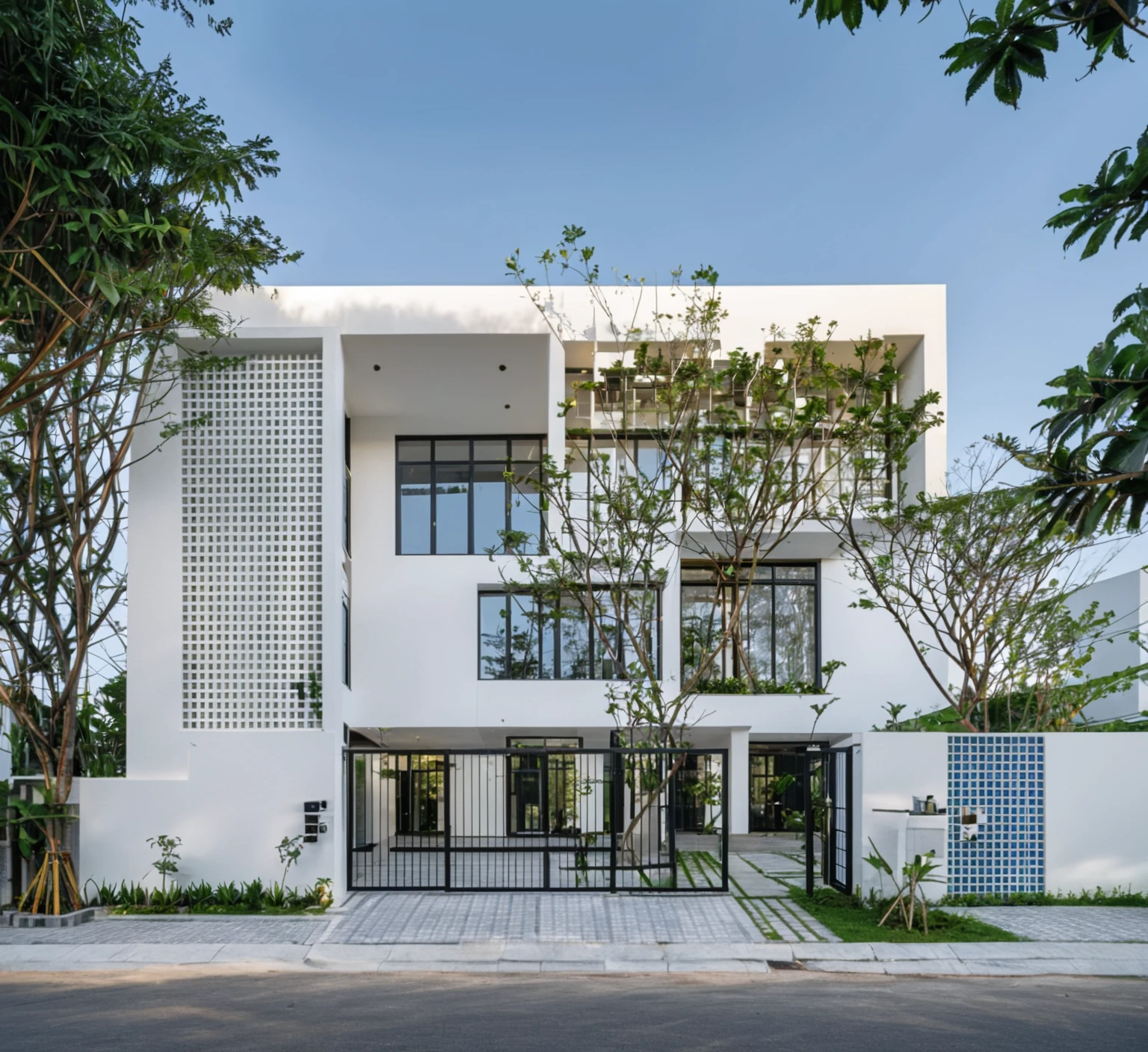 RAW photo , A white minimalism woodandwhite modern house with a double story and simple architecture, surrounded by trees in the yard of Vietnam, featuring a black metal gate and fence, landscape design, natural light, clear sky, blue background, high resolution photography, architectural photography, architectural appearance. The building has square windows made from white ceramic tiles, while the walls feature grid designs, There is also an entrance to another home nearby in the style of architectural photography, road, sidewalk, sidewalk trees, 8k uhd, dslr, soft lighting, high quality, film grain, Fujifilm XT3