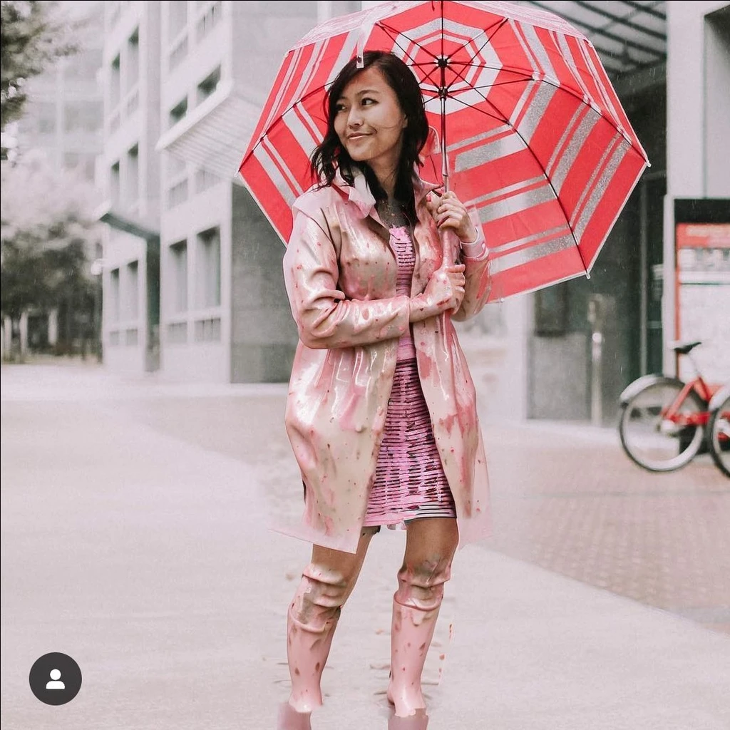 asian lady holding umbrella, cute pose, pink buttoned raincoat, tall pink rain boots, ((((muddy clothes)))), intricate details, highly detailed, masterpiece, 8k, photorealistic, cinematic lighting, vibrant colors, soft focus, elegant, feminine, beautiful, serene, graceful