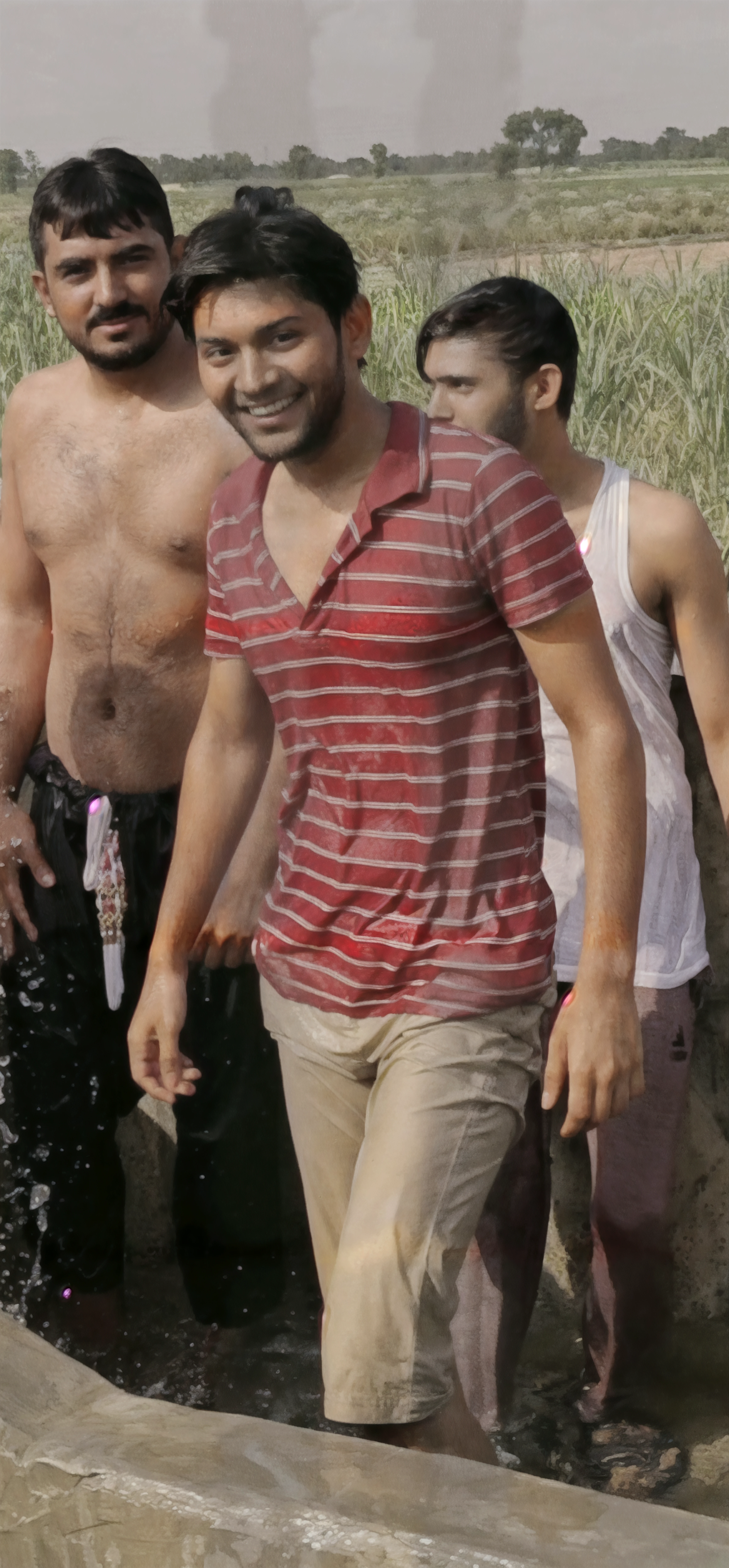 A handsome young Thai ager boy ,15 yr slim underwear and no shirt to ride a motorcycle.,Holding a water gun at the Songkran Festival in Bangkok,Flour smeared,There was a person walking behind him holding a water gun.