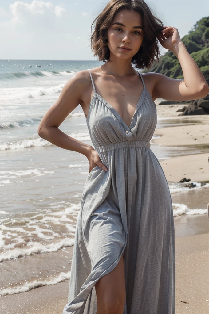 Beautiful bob-haired girl wearing a long dress on the beach