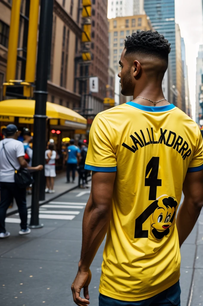 Disney man with his back in New York wearing the yellow Colombia t-shirt with the name Marlon Alexander