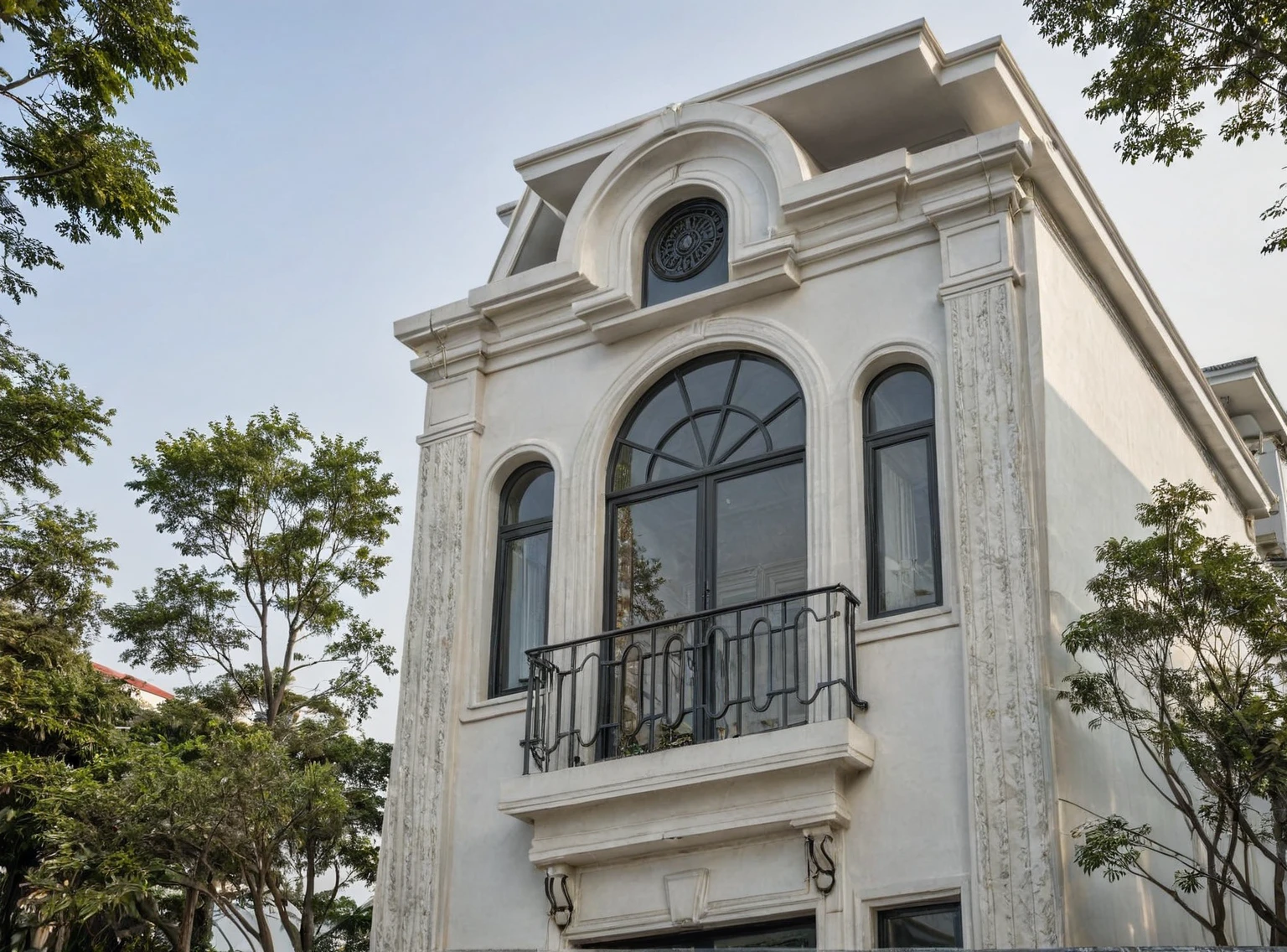 RAW photo,Neoclassical house exterior, Inspired by French architecture, neoclassical style, white, ((Very detailed sculpted moldings at the top of columns and walls)), roof French style house, townhouse in residential area, Building located in a residential area in Hanoi urban area Vietnam, white facade, gray door and gray window facing the street, black steel railing, warm yellow light, (sidewalk), (sidewalk tree), (gate), (surreal), (super detail: 1.5), clean white sky, natural light, (road architecture curl:1.2), (sharpen:1.2), 8k uhd, dslr, soft light, high quality, film grain, Fujifilm XT3