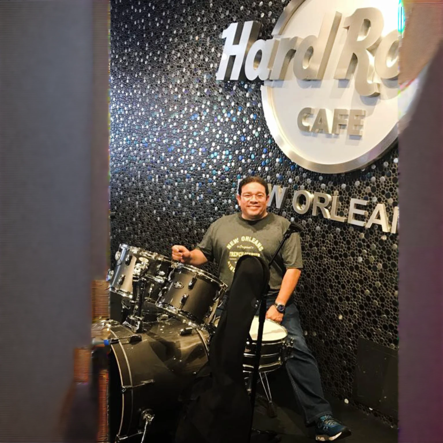 Cafe Arafe in New Orleans with a man sitting on a drum, tocando la battery, captured on iphone, inspired by Ric Nagualero, taken in 2 0 2 0, battery, photo taken in 2 0 2 0, inspired by Willie Ito, taken in the early 2020s, album photo, battery, on the stage