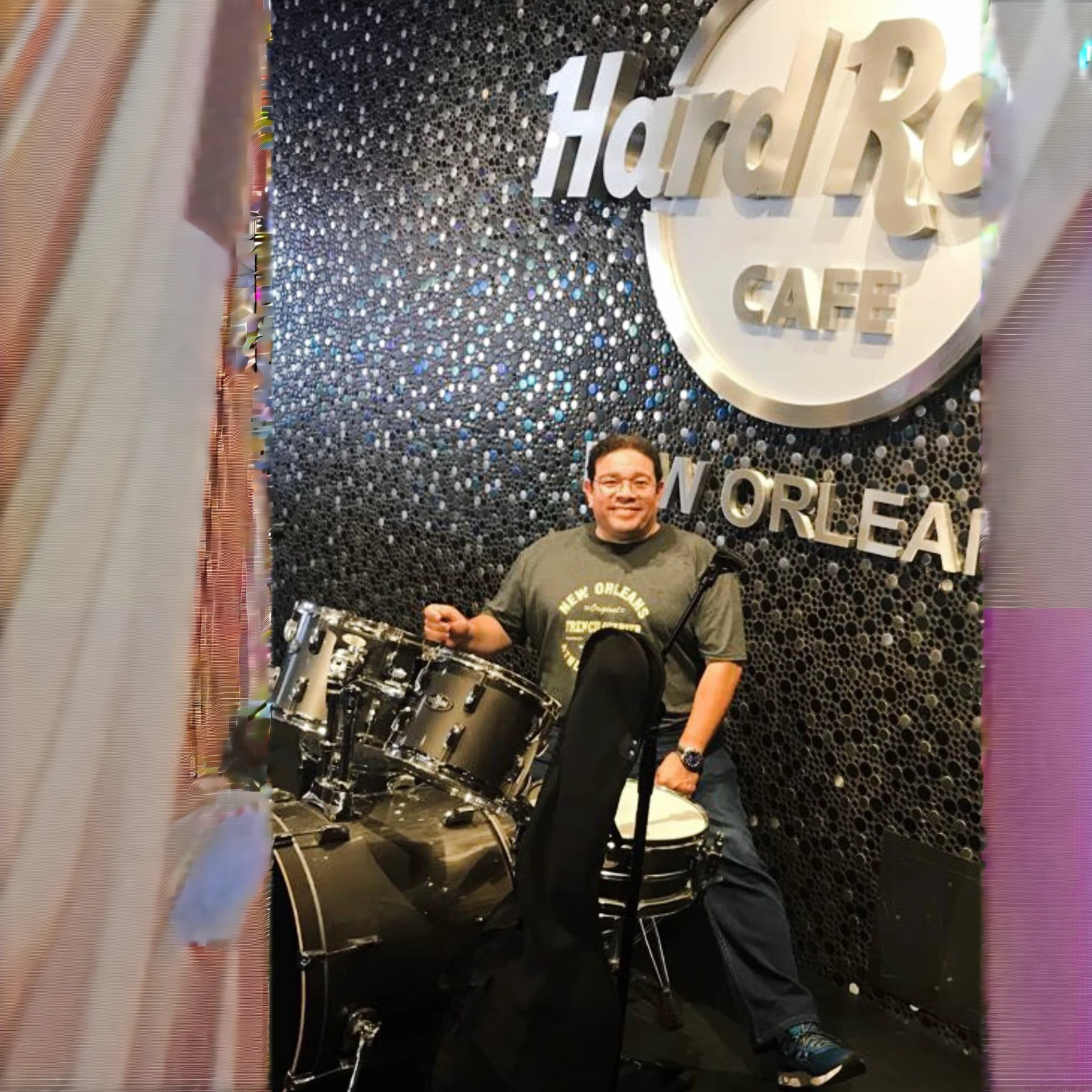 Cafe Arafe in New Orleans with a man sitting on a drum, tocando la battery, captured on iphone, inspired by Ric Nagualero, taken in 2 0 2 0, battery, photo taken in 2 0 2 0, inspired by Willie Ito, taken in the early 2020s, album photo, battery, on the stage