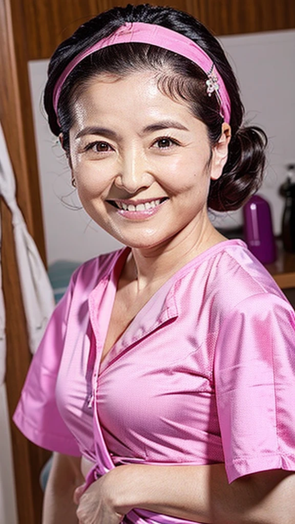 Dental hygienist wearing pink medical scrubs Japanese woman in her 50s with black hair　Upper body close-up　smile　Photo shoot at the clinic　Highest quality