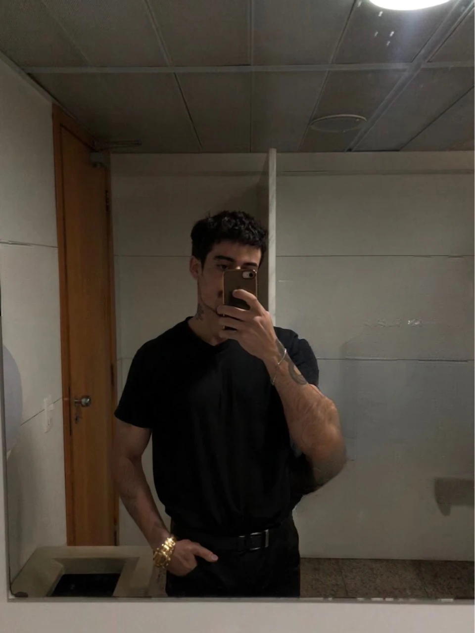 boy, short black hair, intense blue eyes, intense gaze, defined facial features, no facial hair, tall muscular build, broad shoulders, v-shaped body, wolf tattoo on right arm, full body focus, completely hairless, (best quality,4k,8k,highres,masterpiece:1.2),ultra-detailed,(realistic,photorealistic,photo-realistic:1.37),portrait,cinematic lighting,dramatic shadows,dynamic pose,highly detailed