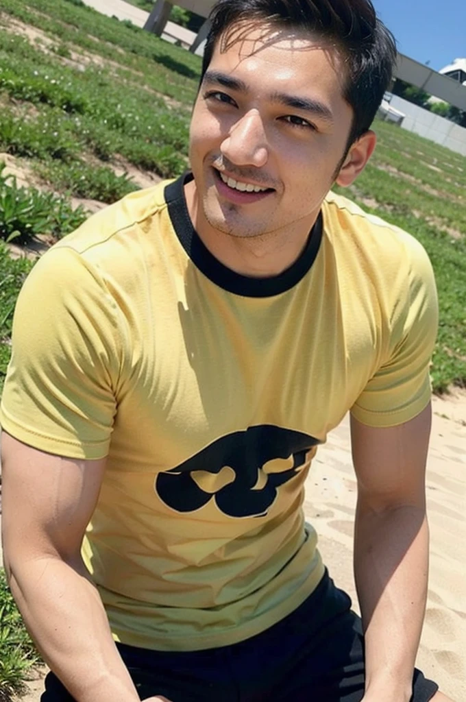 A handsome, muscular young Asian man looks at the camera. In a simple t-shirt black and yellow , Fieldside, grass, beach, sunlight,