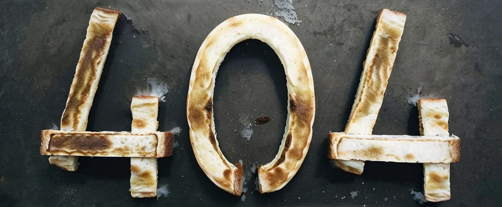 404 bread. 3 pieces of burned bread on a table