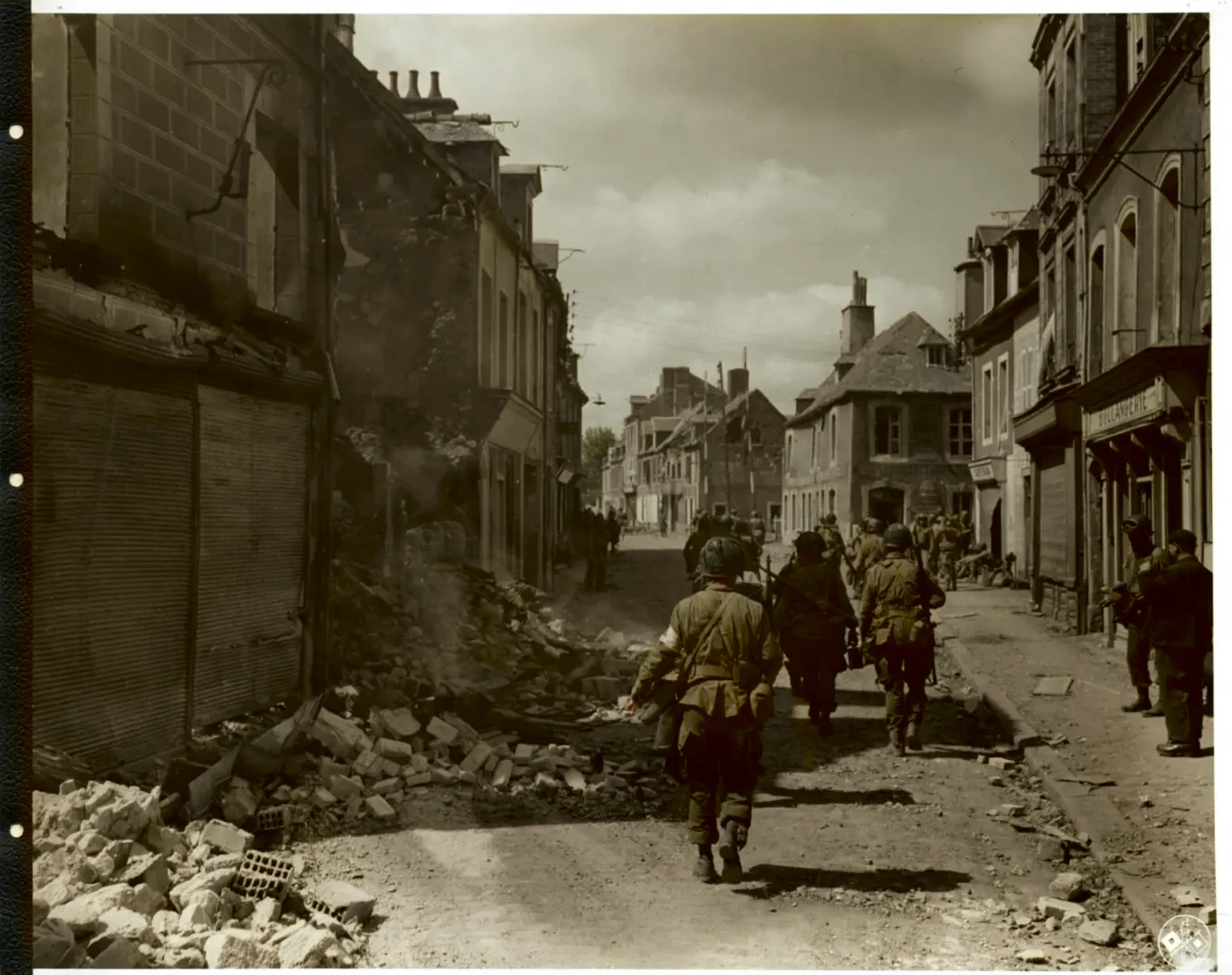 arafed photograph of a group of men walking down a street, ww 2 normandy foy arnhem 1 9 4 4, ww2 normandy foy arnhem 1944, ww2 historical photography, ww 2 historical photography, ww2 photo, ww2 historical photo, troops searching the area, soldiers charging in, 6 june 1944, war photograph