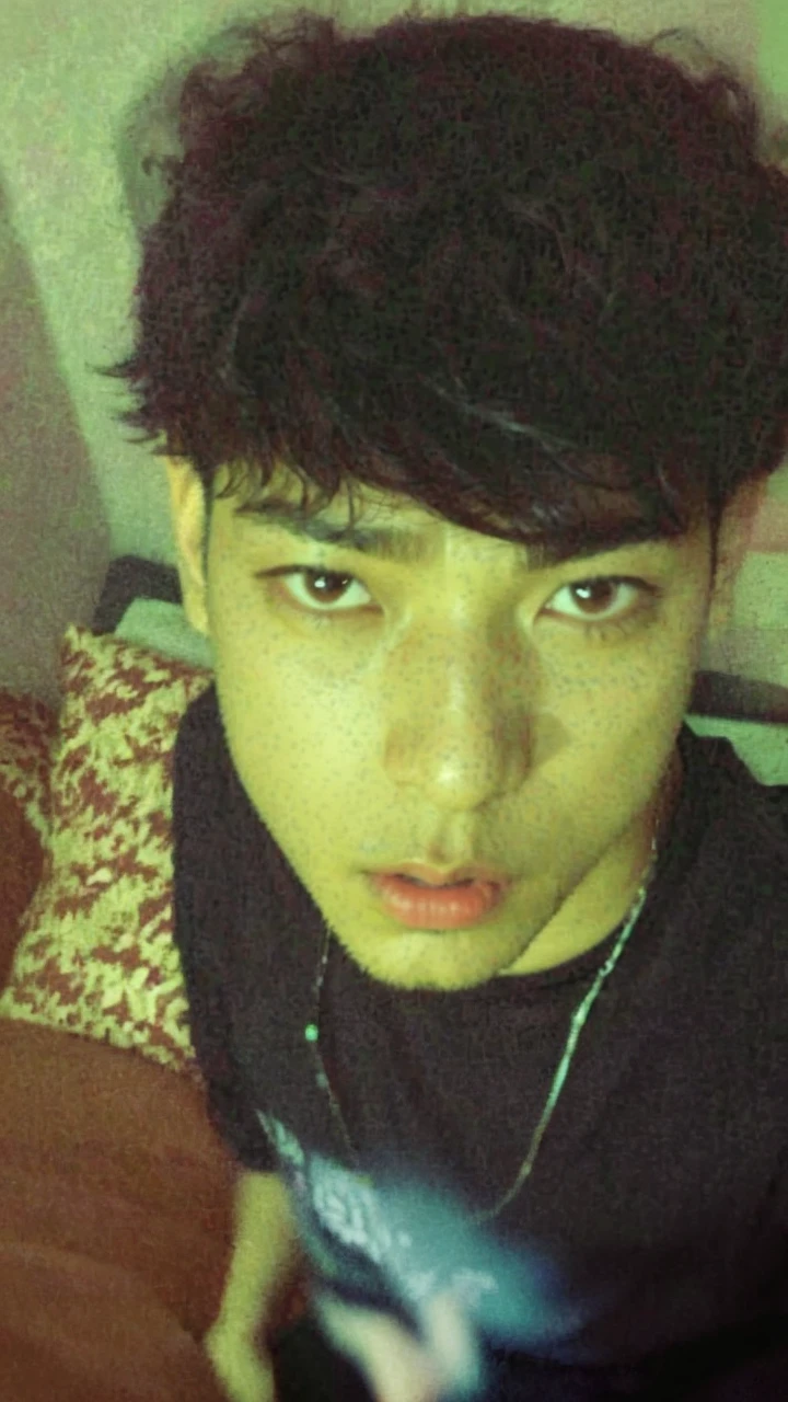 Arafed man in a black shirt sitting on a sofa, jungkook, kim doyoung, Jimin\swollen right eyelid, Wan adorable korean face, Taejune Kim, with the same hairstyle, 1 7 years -  of thin face age, He grabs his bangs in one hand, short hair on top of your head, hyung tae