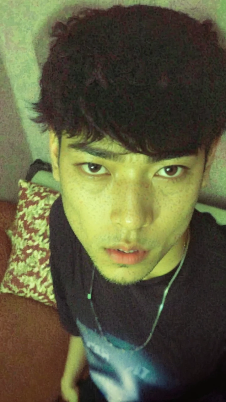 Arafed man in a black shirt sitting on a sofa, jungkook, kim doyoung, Jimin\swollen right eyelid, Wan adorable korean face, Taejune Kim, with the same hairstyle, 1 7 years - of thin face age, He grabs his bangs in one hand, short hair on top of your head, hyung tae
