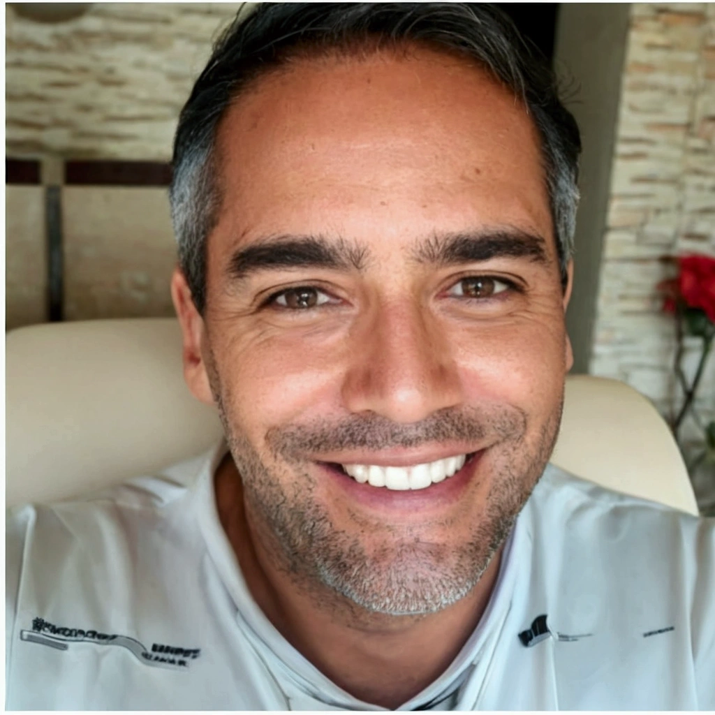 smiling man, with gray hair and white shirt, seated in a chair, icaro carvalho, gui guimaraes, miguel iglesias, edu souza, david rios ferreira, caio santos, Andreia Rocha, carmelo blandino, by Felipe Device, luis melo, henrique alvim corrêa, michael vicente, joe alves