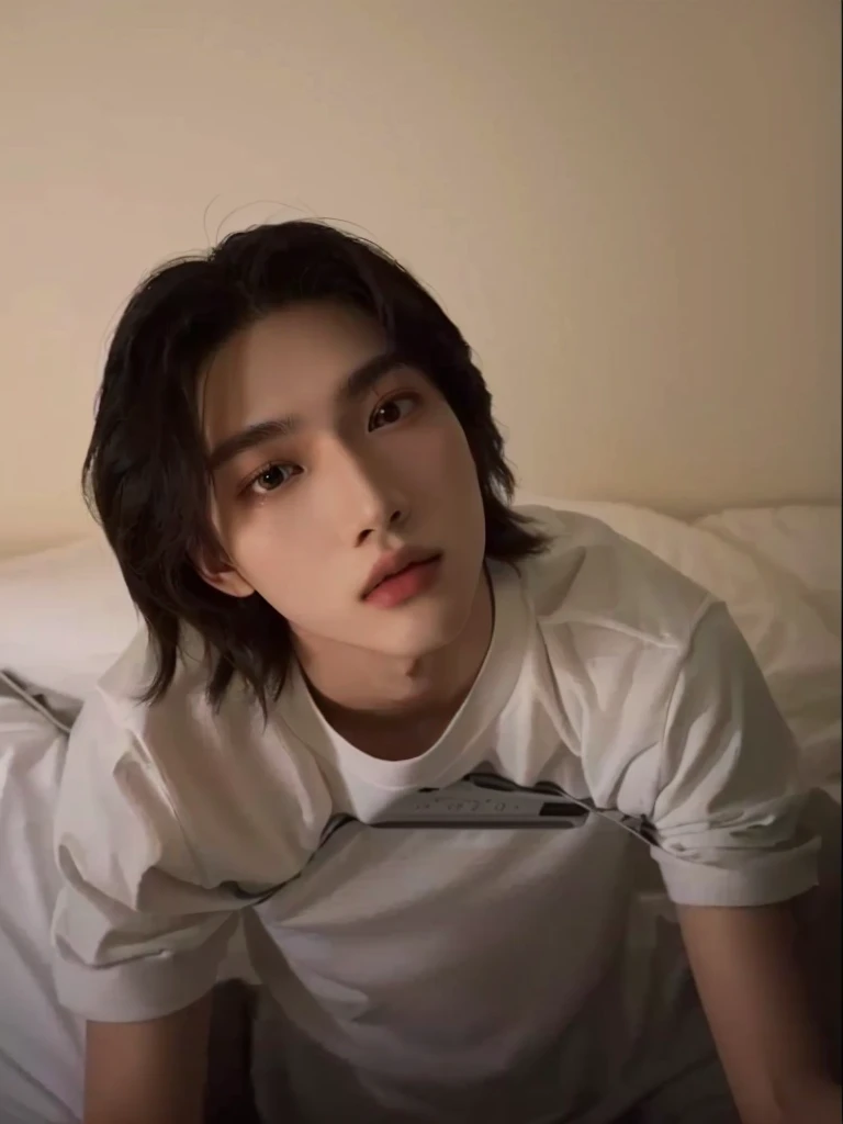 A man is sitting on a bed with a remote control in his hand, Tommy 1 6 years old, One boy, 7 years old, Thin face, Xiaolong, xqc, 18-year-old, androgynous face, Cai Xukun, Cute androgynous prince, A delicate androgynous prince, profile image
