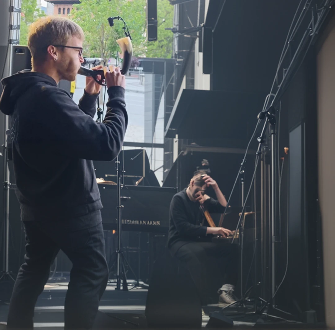 Playing a concert on a stage.