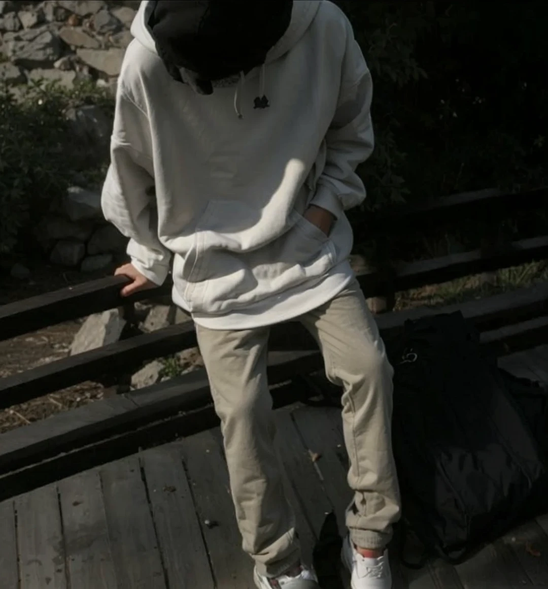 Young cute Guy in a hoodie hiding his face