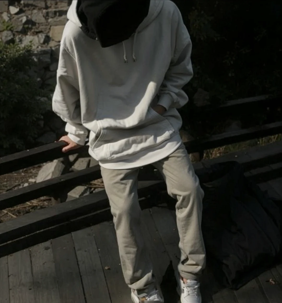 Young cute Guy in a hoodie hiding his face