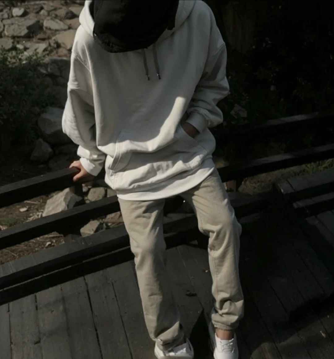 Young cute Guy in a hoodie hiding his face