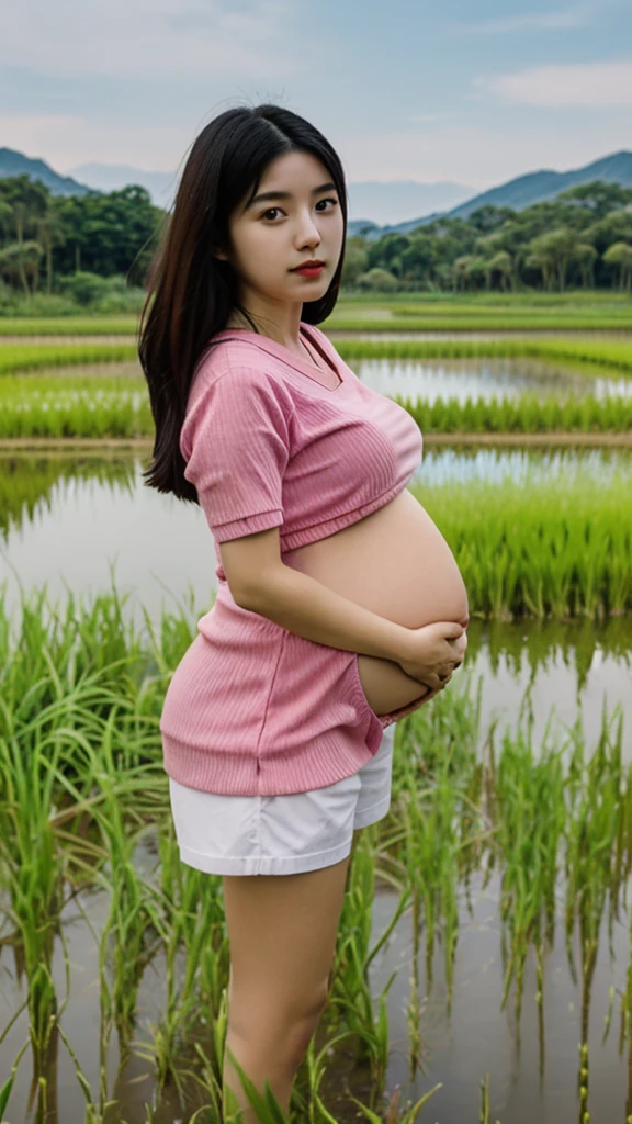 Beautiful young 17 year old Japanese woman, 4 months pregnant wearing a pink shirt wearing sexy white shorts
place in the rice fields