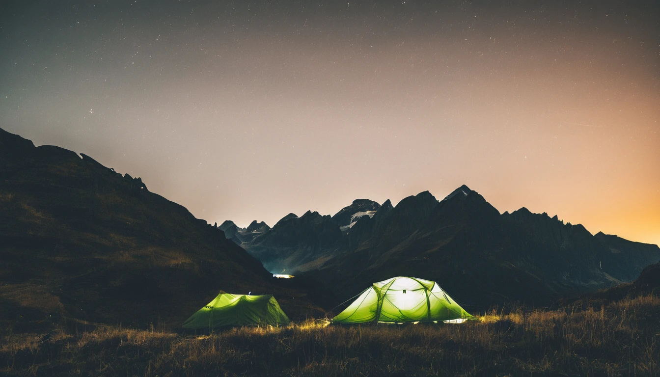 a tent is lit up at night in the mountains