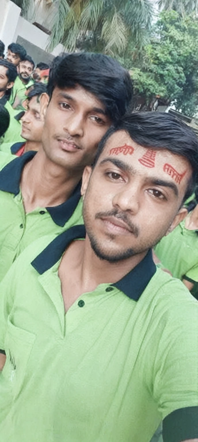 there are two men in green shirts posing for a picture, third eye in middle of forehead, india tika third eye, showing forehead, markings on his face, candid picture, third eye middle of forehead, profile pic, very very low quality picture, shaved temple, candid photo, inspired by Kailash Chandra Meher, buzzed hair on temple, with kind face improve the quality 