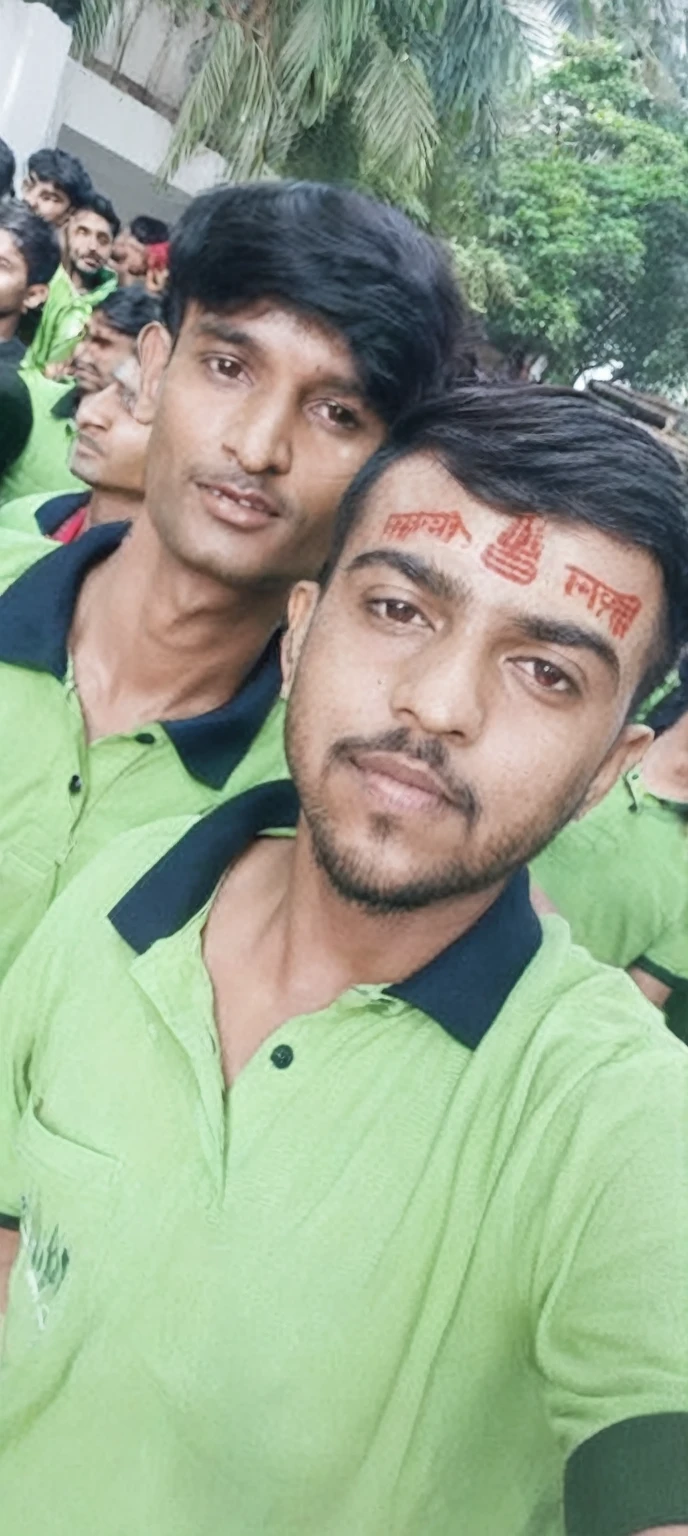 there are two men in green shirts posing for a picture, third eye in middle of forehead, india tika third eye, showing forehead, markings on his face, candid picture, third eye middle of forehead, profile pic, very very low quality picture, shaved temple, candid photo, inspired by Kailash Chandra Meher, buzzed hair on temple, with kind face improve the quality