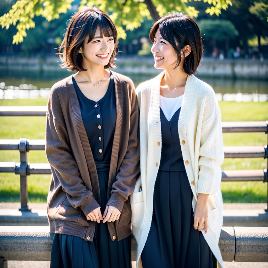 Two Japanese women taking photos in a park along the Sumida River in Japan、She is a 27-year-old woman.、Loose, Fluffy short hair and lob hair、One was a 31-year-old woman.、The chest is small、There is a dark brown lobe、the two are having fun、、small、Modest chest、Street Snap、Adult Women's Plain Clothes、Sailor suit、cardigan、Transparent feeling、Beautiful woman、Look at me with a smile、Gazing at each other